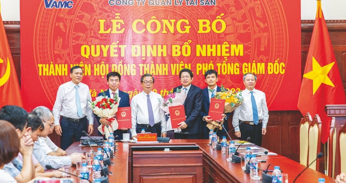Phó Thống đốc NHNN Nguyễn Kim Anh trao quyết định và tặng hoa tại Lễ Công bố quyết định bổ nhiệm Thành viên Hội đồng thành viên, Phó Tổng Giám đốc VAMC
